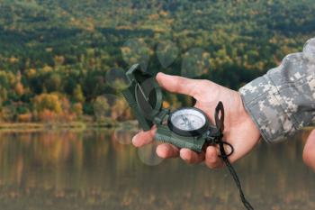 Man with compass in hand n Altai mountains. Travel concept.