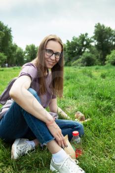 Woman feeding gopher in the summer park