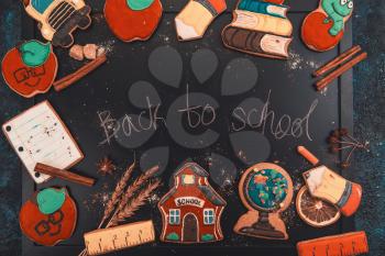 Back to school concept made with gingerbreads cookies on a blackboard background
