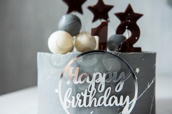 Birthday cake with decoration on white table. Twelve years birthday