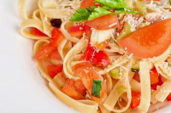 Penne pasta with parmesan cheese, herbs, tomatoes and basil