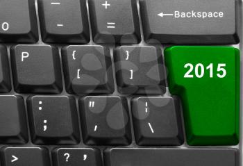 Close-up of computer keyboard with  green twenty fifteen new year key