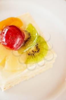 tasty fruit dessert with plum, pineapple and kiwi