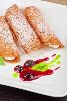 Sicilian cannoli at plate decorated with lime and jam