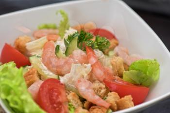 Caesar shrimp salad with cheese and arugula