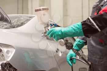 spray gun with paint for painting a car 