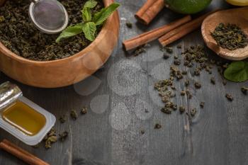 tea composition with cinnamon sticks, lemons and lime