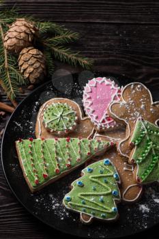 New year homemade gingerbreads on wooden background. Christmas theme.