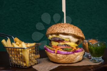 Tasty classical burger with fried potato
