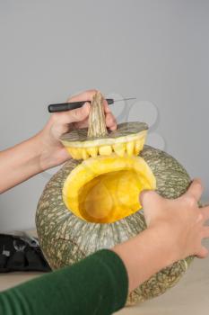 woman hands making pumpkin for halloween holidays.