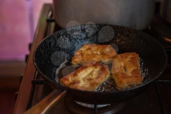 Grandmother bakes pies on the pan and serves to the table