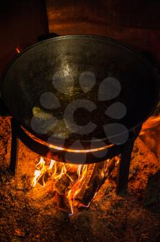 Camping fire and kettle with frying fish