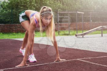 A young beauty athletic woman in sportswear preparing for running at outdoor early morning. Healthy lifestyle.