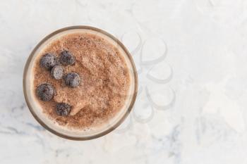 Chocolate smoothie on a white concrete background