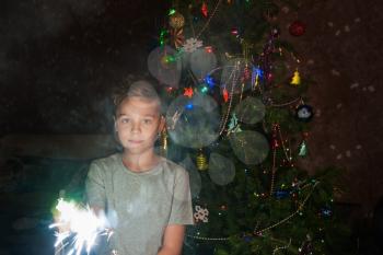 Boy make a wish on New Year with sparkle in the hands