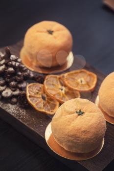 Tasty dessert as orange fruit with chocolate fir-tree for new year holiday