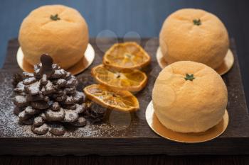 Tasty dessert as orange fruit with chocolate fir-tree for new year holiday