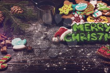 Different ginger cookies and coffee for new years and christmas on wooden background, xmas theme. Top view.