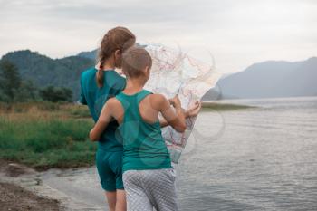 Woman and her son seeing the map on Teletskoye lake in Altai mountains, Siberia, Russia.