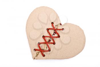 Royalty Free Photo of a Torn Cardboard Heart Stitched With a Red Shoelace