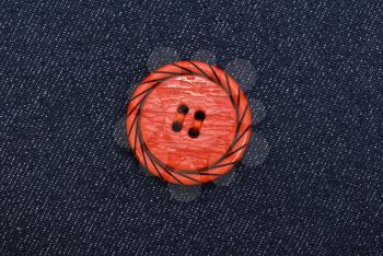 Royalty Free Photo of a Red Button on Jeans