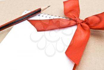 Royalty Free Photo of a Spiral Notepad With a Red Bow