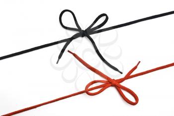 Royalty Free Photo of Black and Red Shoelaces Tied in Bows
