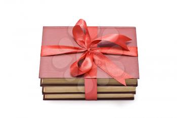 Pile of books with red ribbon and bow 