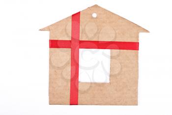 Cardboard house with red ribbon