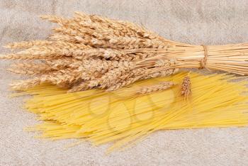 Spaghetti and wheat ears on sacking