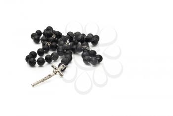 Black beads isolated over white with focus on cross (shallow DOF)