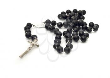 Black beads over white (Shallow DOF) with focus on the cross