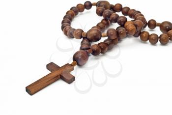 Brown Wooden beads isolated over white with focus on cross (shallow DOF)