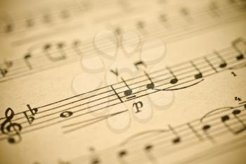 Classical music - notes on yellowed vintage paper sheet (shallow DOF)