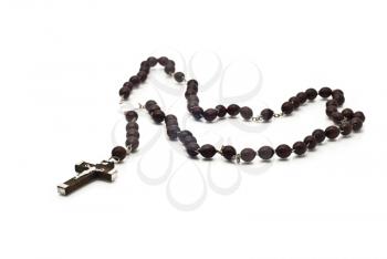 Closeup of beautiful Wooden beads isolated over white (shallow DOF). Focused on the christ