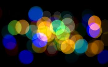 Colorful Blurred lights over black useful as holiday background

