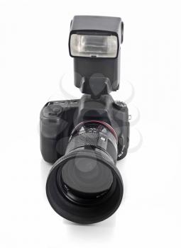 Professional DSLR camera with telephoto lens and flash isolated over white