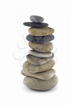 Stability - Balanced pebble stack or tower isolated over white