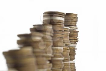 Towers assembled of money. Recession or growth (coins). Shallow DOF with focus on the back tower