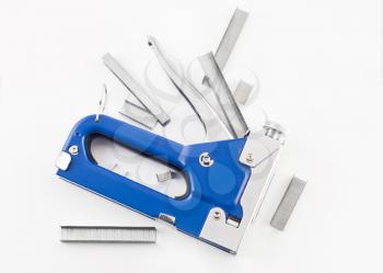Blue staple gun with staples isolated over white background