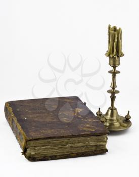 An old candlestick with antique book
