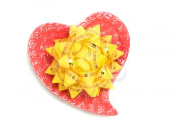 Love - yellow bow on red heart over white background