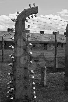 Wire fence and barracks in Auschwitz - Birkenau concentration camp, Poland