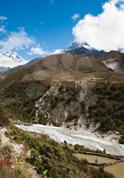 Himalayas: stream and Lhotse, Lhotse shar peaks. Pictured in Nepal 