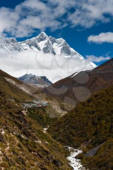 Summits Lhotse and Lhotse shar. Village and stream in Himalayas. Pictured in Nepal