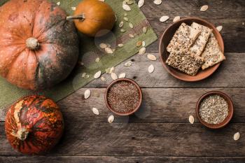 Rustic style autumn pumpkins with cookies and seeds on wood. Autumn Season food photo