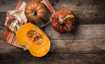 Rustic style pumpkins  with napkin and wood . Autumn Season food photo