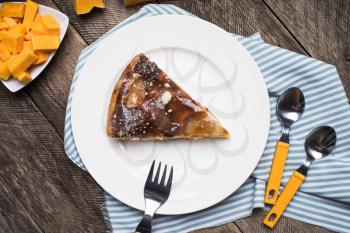 Lunch pie on plate and pieces of pumpkin in Rustic style. Food Photo