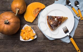 pumpkins and pie on plate in Rustic style. Food photo