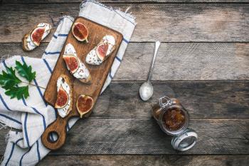 Bruschetta snacks with jam and figs rustic style. Breakfast, lunch food photo